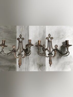Early 20th Century pair of ornate bronze wall sconces with lyre motifs.